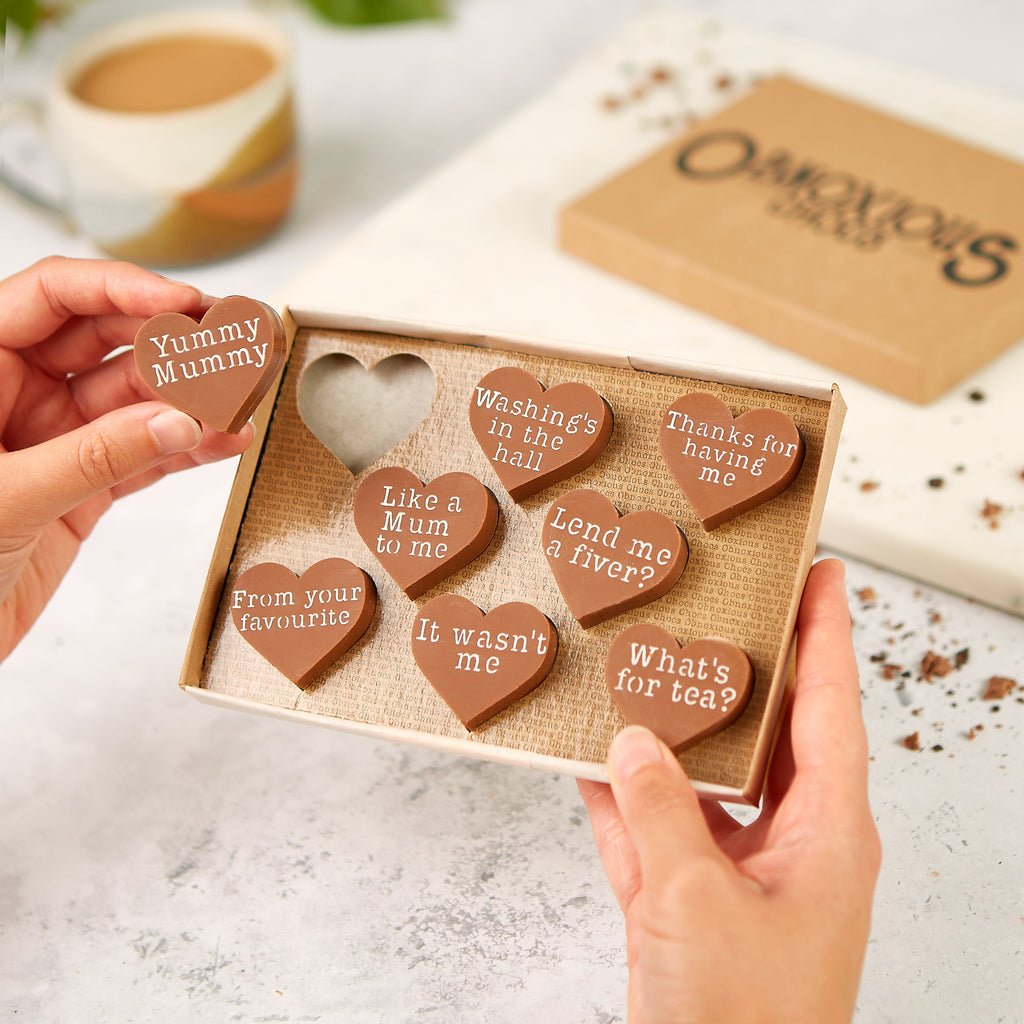 A selection of Obnoxious Chocs for Mum in their gift box, highlighting a chocolate with a 'Yummy Mummy' slogan