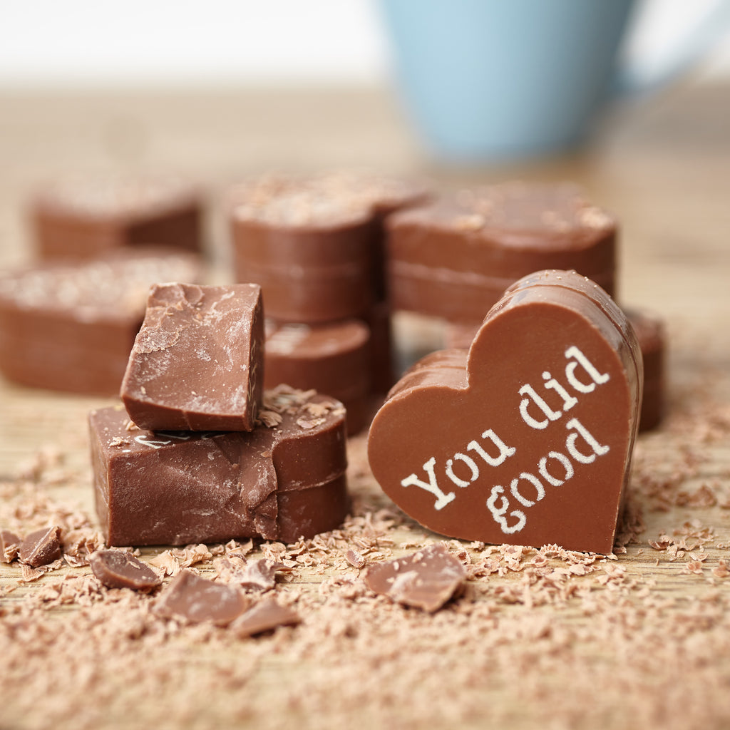 A close up view of the chunky solid Belgian chocolate centres of the thank you chocolate hearts focusing on a 'You did good' message