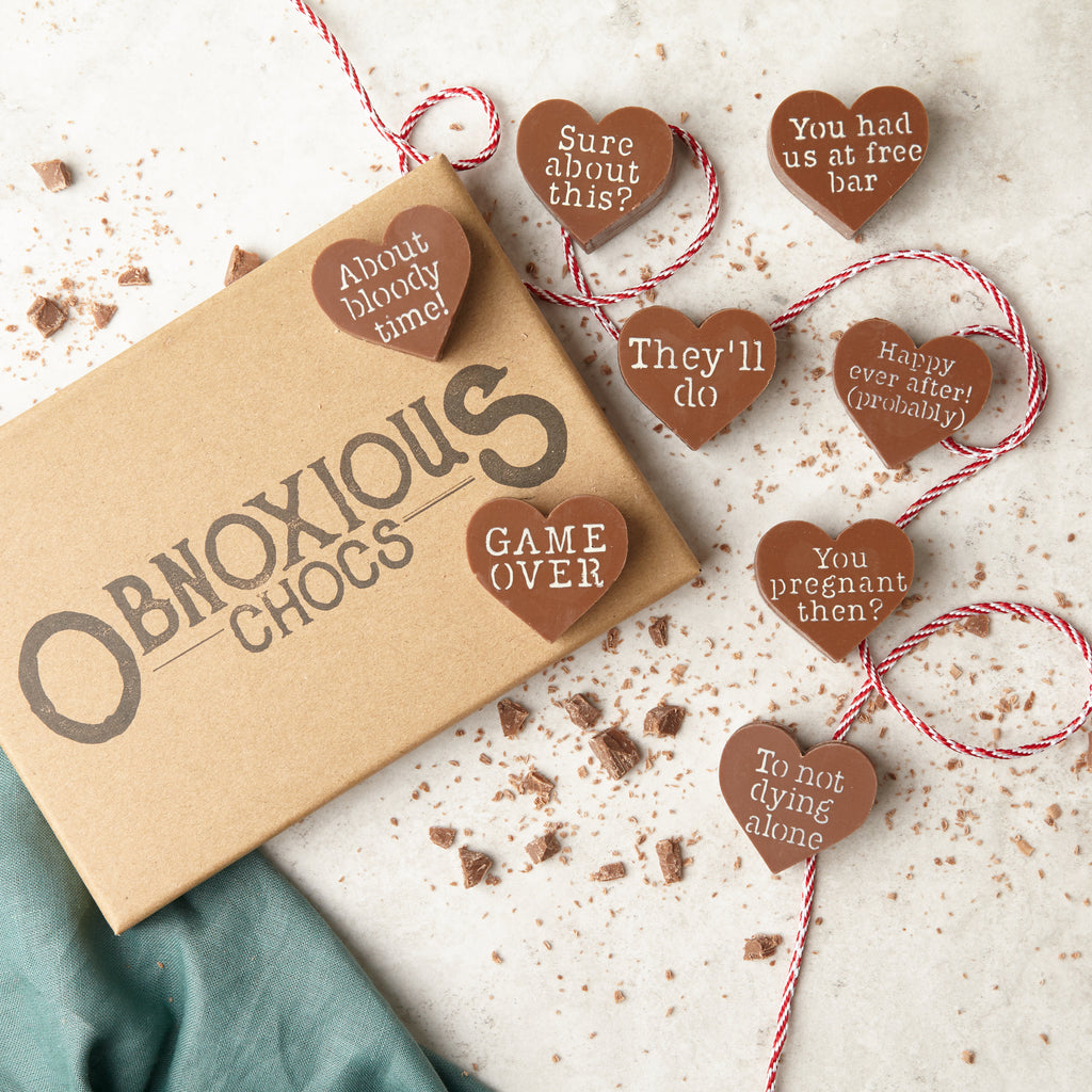 Flat lay view of the eight milk chocolate hearts in the Obnoxious Chocs engagement collection