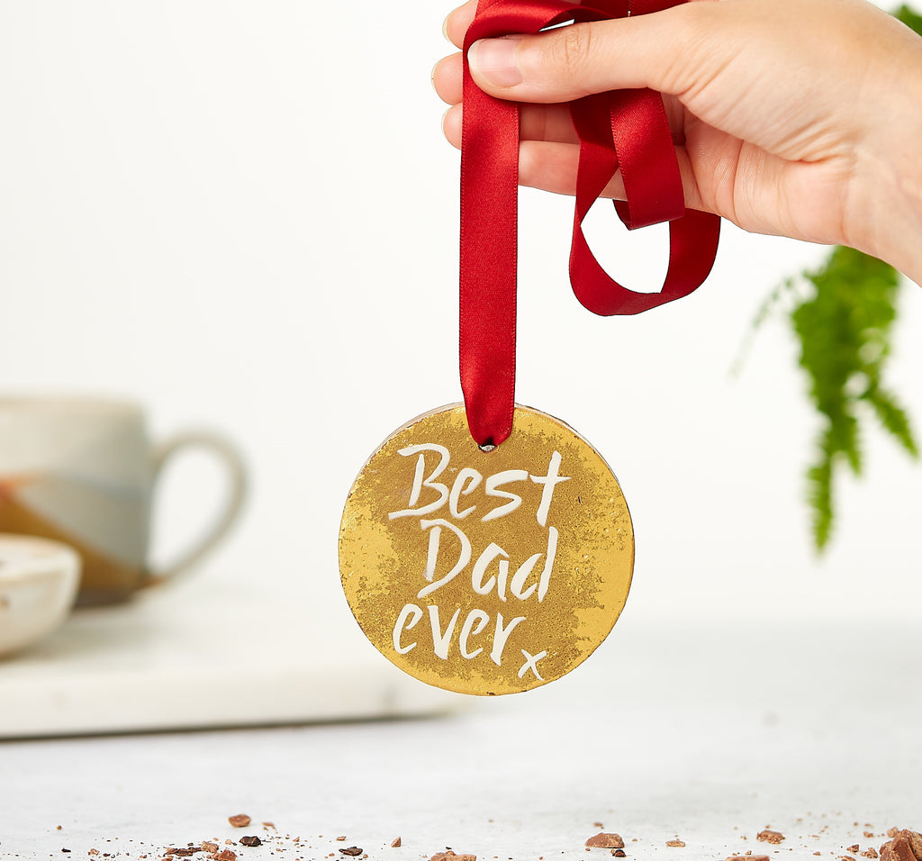 Shiny gold chocolate medal on a red ribbon decorated with a 'Best Dad Ever' message