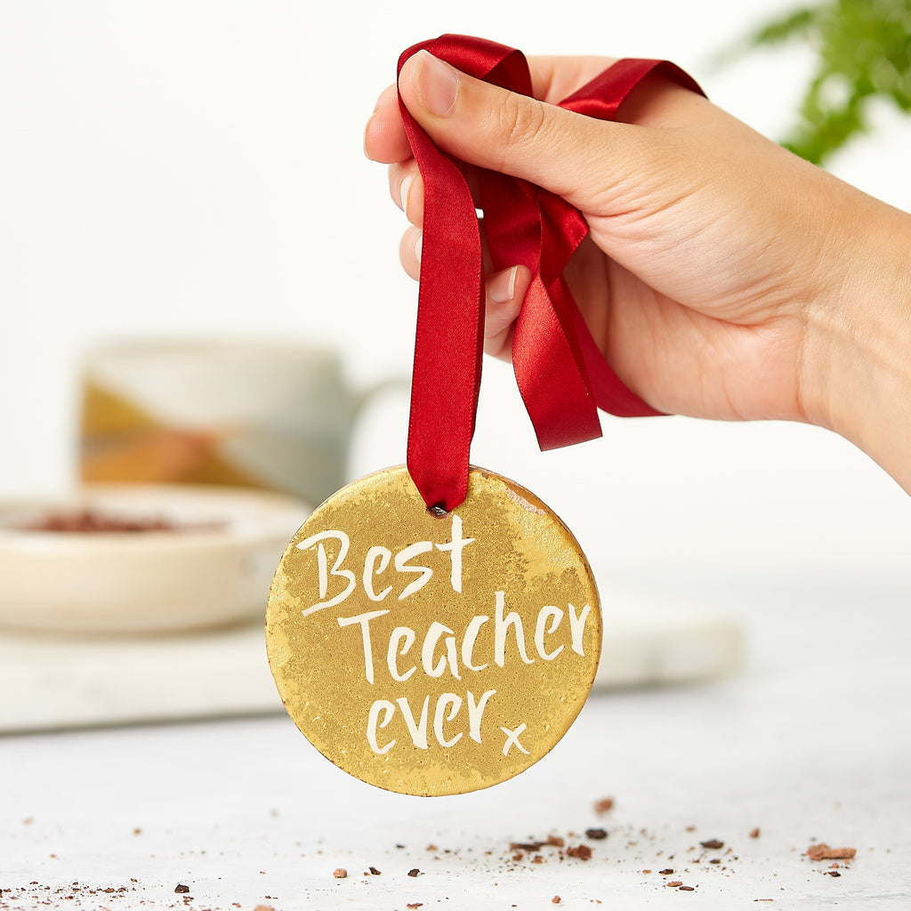 Belgian chocolate gold medal dangling by a red ribbon and sporting a 'Best teacher ever' message