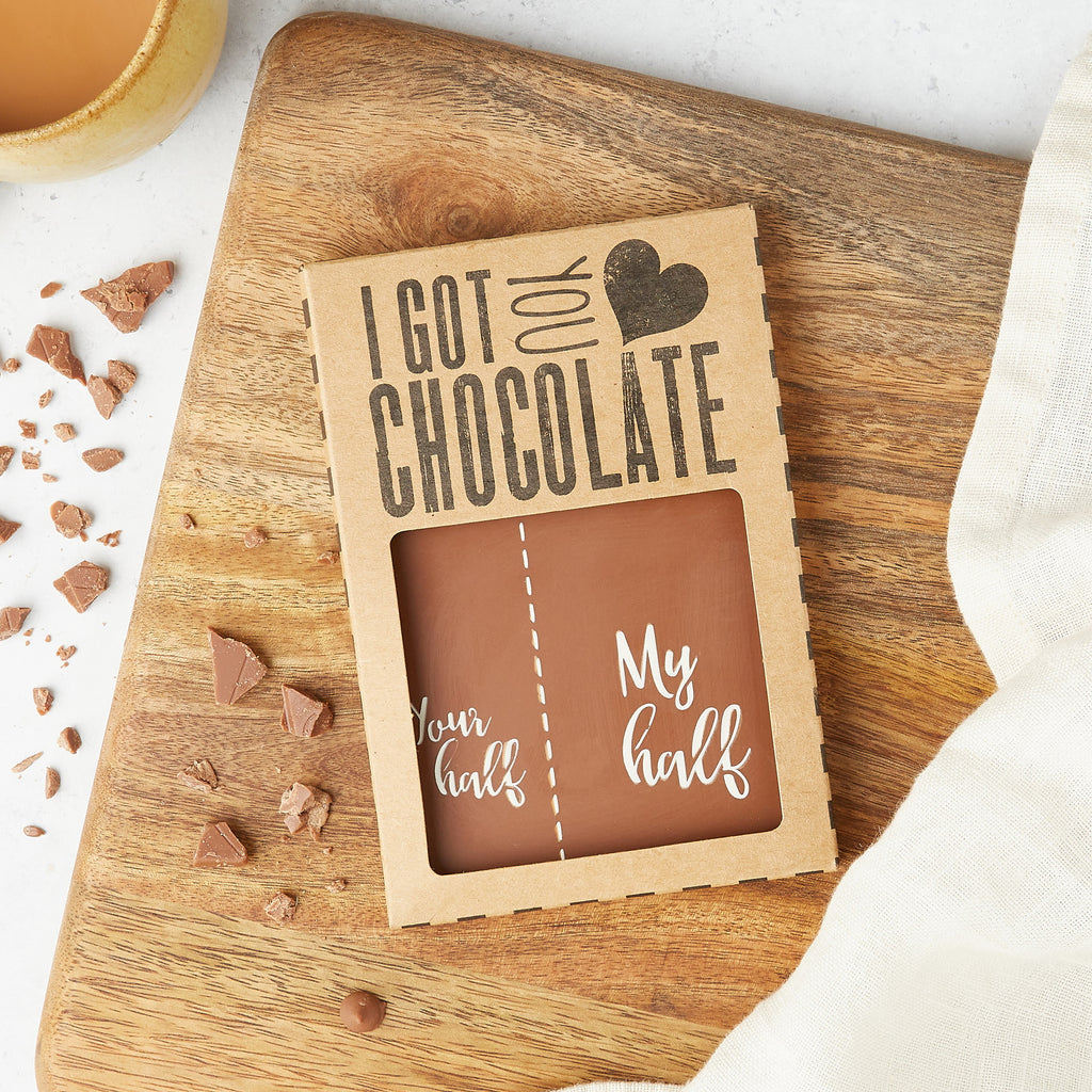 A chocolate bar decorated with a cheeky 'your half/my half' motif packaged into an 'I got you chocolate' gift box